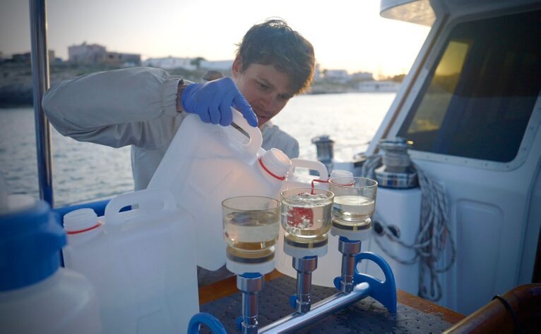Jeremy filtering seawater samples for environmental DNA on the deck of a boat